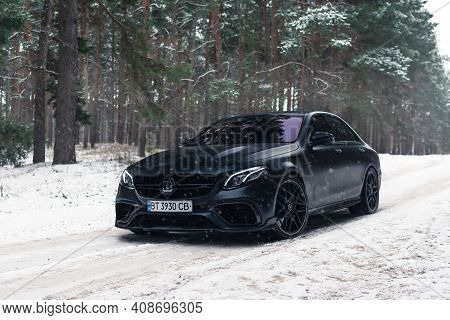 Kherson, Ukraine - February 2021. Powerful Mercedes-amg E63s Brabus 800 In A Black Color In The Wint