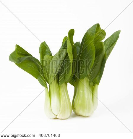 Young Fresh Pak Choi Vegetables Over White Background