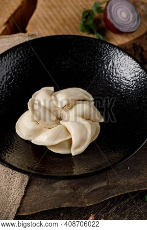 Appetizing Traditional Russian Dumplings, Hand-made With Potatoes. Still Life On A Wooden Board. Clo
