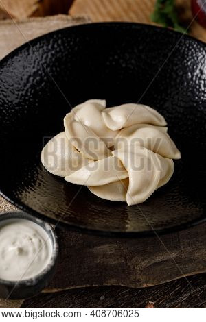 Appetizing Traditional Russian Dumplings, Hand-made With Potatoes. Still Life On A Wooden Board. Clo