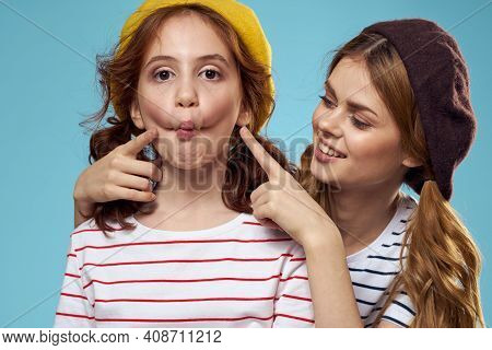 Mom And Daughter Striped T-shirts Hugs Fun Lifestyle Blue Background