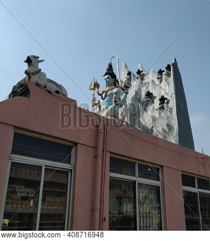 Closeup Of Beautiful Hindu God Lord Shiva Statue At The Top Of The Temple With Snow Background