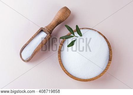 Natural Sweetener In A Wooden Bowl On A Pink Background. Sugar Substitute. Erythritol.