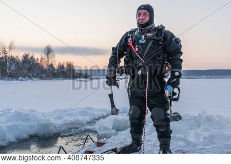 Russia, River Volga Kama - Jan 17th 2020. Diver Before Scuba Ice Diving. Outdoor Winter Diving Under