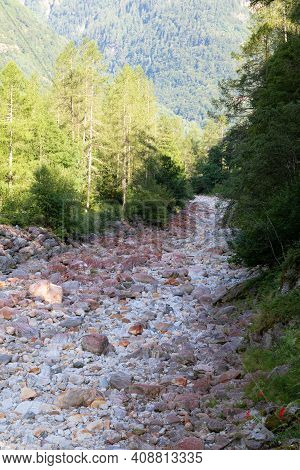 Switzerland, Verzasca Valley: Dry Streambed With Many Red Washed Out Stones, In Some Summers It Is V