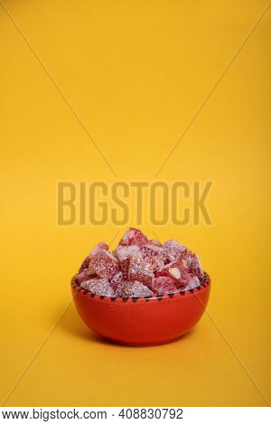 Red Bowl Of Rahat Lakoum Isolated On Yellow Background. Turkish Sweet Concept. Vertical Image. Image