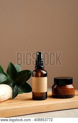 Natural Organic Spa Cosmetic Products Set With Green Leaves. Herbal Skincare Beauty Products On Wood