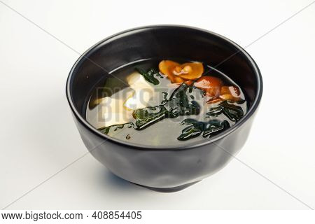 Miso Soup In A Black Carriage. Ingredients Broth, Tofu Cheese, Naimeko Mushrooms, Miso Paste, Hondas