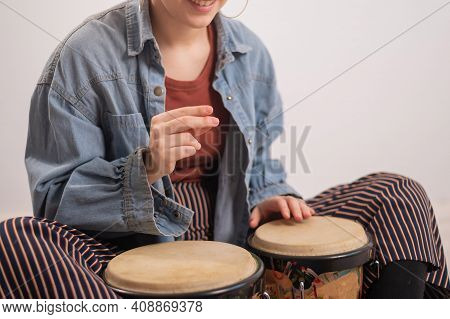Young Faceless Caucasian Woman Playing Small Ethnic Drums