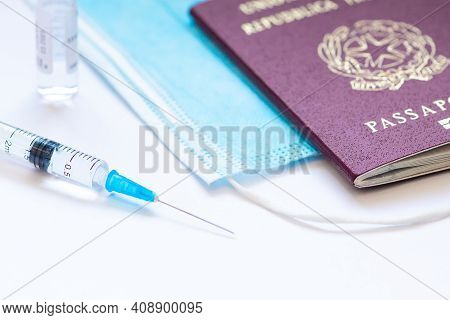 Rome, Italy - February 19 2021: Syringe With Needle, Vial, Surgical Face Mask And Passport Or Visa O