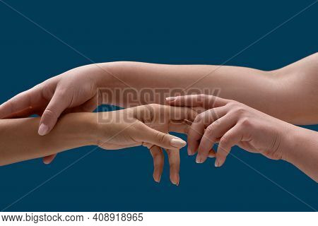 Close Up Of Two Female Arms Holding Each Other To Symbolize Taking Care Isolated Over Blue Backgroun
