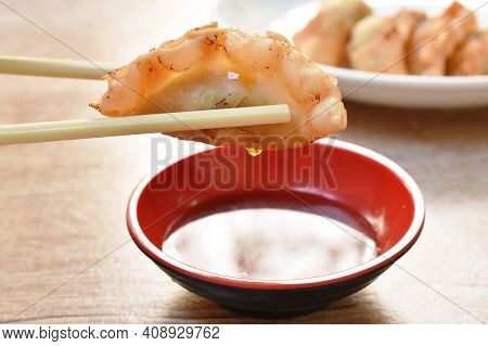 Crispy Fried Gyoza Or Japanese Dumpling Stuffed Mashed Pork Dipping Shoyu Sauce On Plate