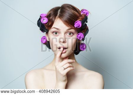 Wind Curls Of Hair Purple Curlers On The Head Of A Red-haired Woman