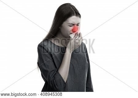 Young Woman With Tissue Sneezing On Light Background, Toned In Black And White. Runny Nose