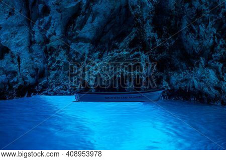 Bisevo, Croatia - Aug 16, 2020: Tourists On A Boat In Serene Blue Cave Near Komiza Island