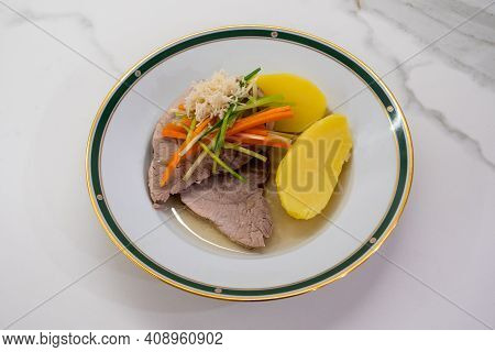 Stewed Pork With Root Vegetable Julienne Of Carrots, Leeks, Horseradish And Potatoes Called Steirisc