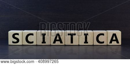 Sciatica Symbol. Wooden Cubes With Word 'sciatica'. Beautiful Grey Background. Medical And Sciatica 