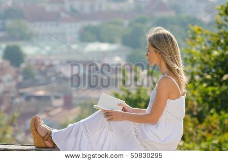 young woman reading book in Vilnius, Lithuania