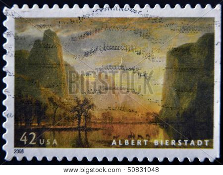 A stamp printed in USA shows a picture of the Rocky Mountains by Albert Bernstein