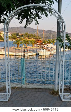 Ships in a harbor of Neos Marmaros at golden hour, Sithonia