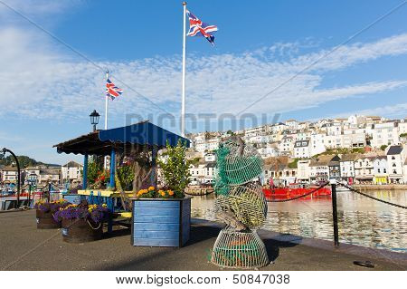 Colourful flowers and union jack flags at harbourside Brixham harbour Devon