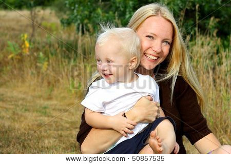 Happy Mother And Baby Boy Outside