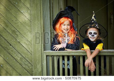 Portrait of two Halloween girls looking at camera