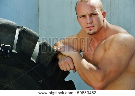 Athletic strong bodybuilder, execute exercise training in sport gym hall