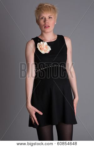 Portrait of beautiful blonde woman in black dress.