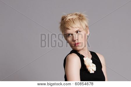 Portrait Of Beautiful Young Blonde Girl In Black Dress. Fashion Photo