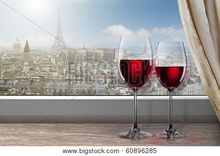 View of Paris and Eiffel tower from window with two glasses of wine