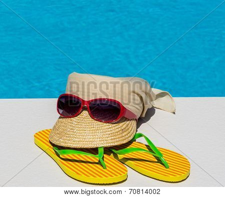 utensils for a nice and relaxing vacation day lying next to a swimming pool. relaxation on holiday.
