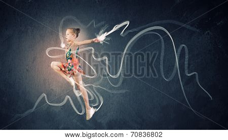 Little cute girl gymnast making high jump