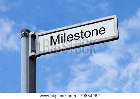 Signpost With Milestone Sign Against Sky
