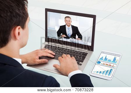 Businessman Video Conferencing On Laptop In Office