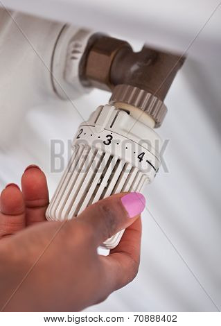 Woman Adjusting Thermostat