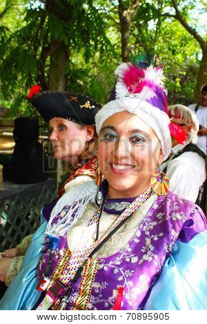MUSKOGEE, OK - MAY 24: Women dressed in historical costume enjoys her day at the Oklahoma 19th annual Renaissance Festival on May 24, 2014 at the Castle of Muskogee in Muskogee, OK. 