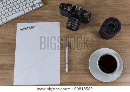 Desktop With Camera Blank Sheet And Coffee