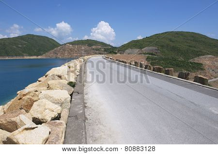 Road over the dam of the High Island Reservoir at the Hong Kong Global Geopark Hong Kong, China.