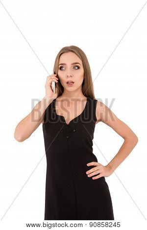Girl In A Black Dress On A White Background. Girl Talking On The Phone.