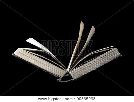 Old Open Book Isolated On A Black Background