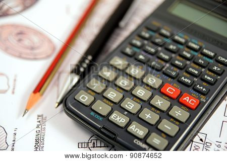 Scientific calculator, Pen and Pencil over the Engineering Drawing Map