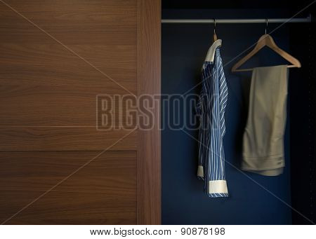 Clothes Hung Neatly In Wardrobe Wood