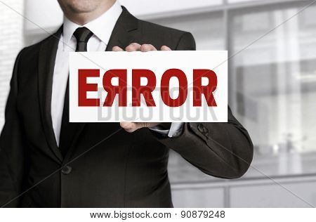 Error Sign Held By Businessman