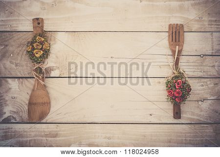 Wooden background with kitchen utencils