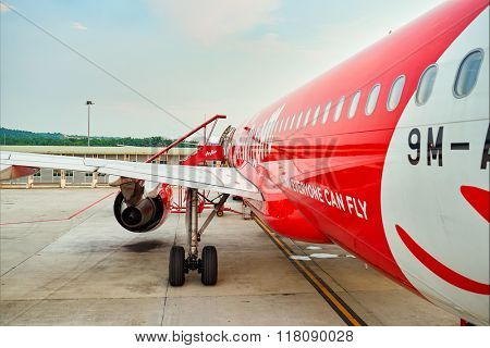 KUALA LUMPUR, MALAYSIA - MAY 02, 2014:  AirAsia flight in the airport. AirAsia Berhad is a Malaysian low-cost airline headquartered near Kuala Lumpur, Malaysia