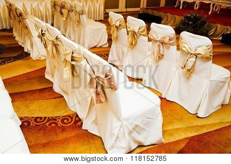 The back of yellow and gold wedding chairs