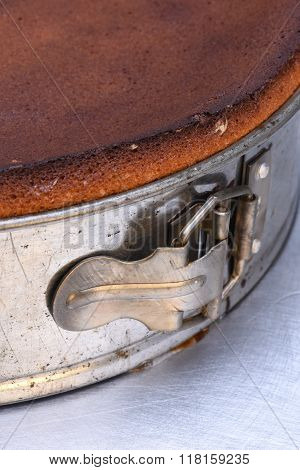 Close up of metal springform with fresh cake
