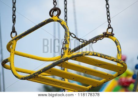 Yellow seat suspended on chains