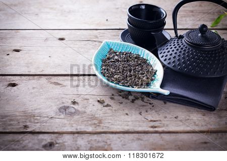 Green Tea In Bowl And Traditional Asian Tea Set  On Aged Wooden Background.